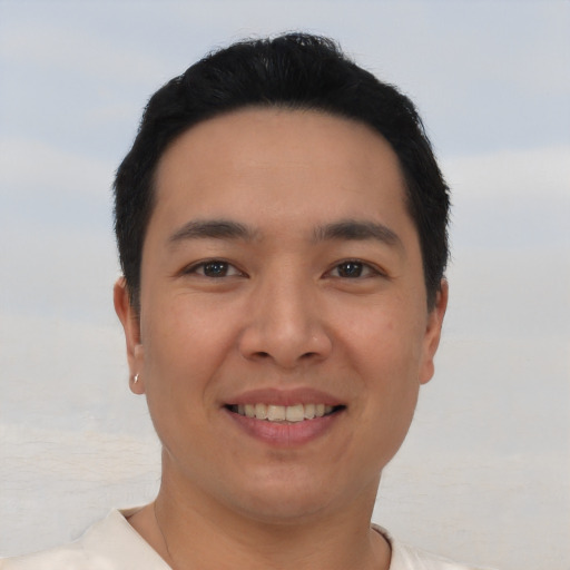 Joyful asian young-adult male with short  black hair and brown eyes