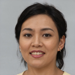 Joyful asian young-adult female with medium  brown hair and brown eyes