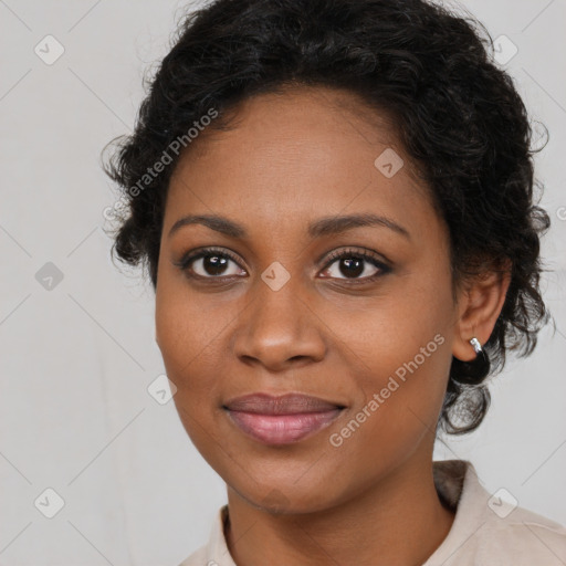 Joyful black young-adult female with long  brown hair and brown eyes