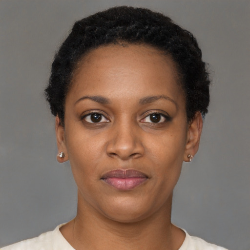 Joyful black young-adult female with short  black hair and brown eyes