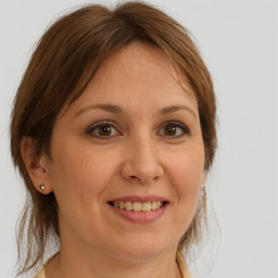 Joyful white adult female with medium  brown hair and brown eyes