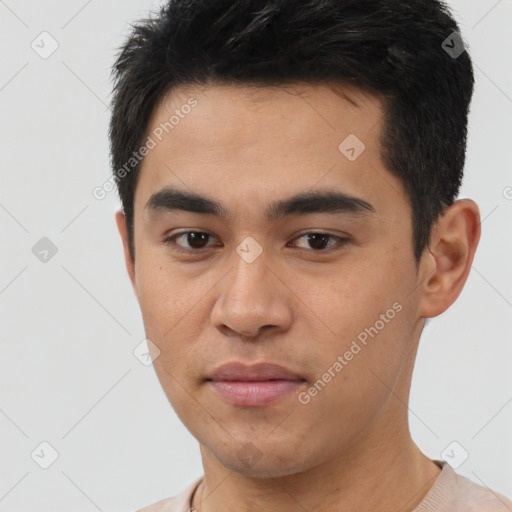 Joyful white young-adult male with short  black hair and brown eyes