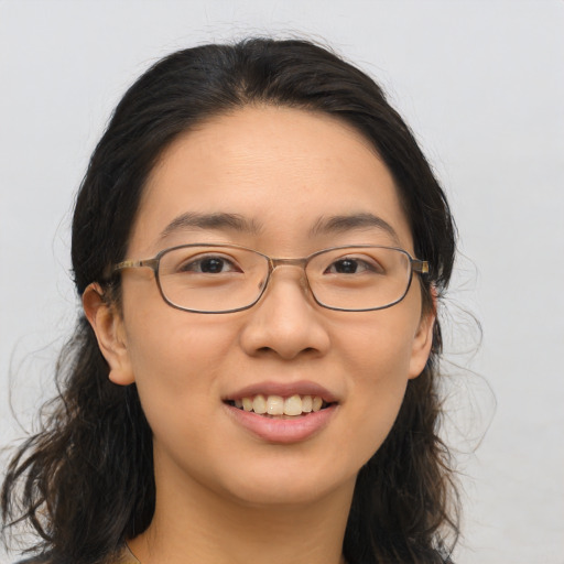 Joyful asian young-adult female with long  brown hair and brown eyes