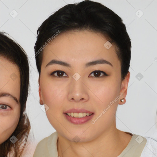 Joyful asian young-adult female with medium  brown hair and brown eyes