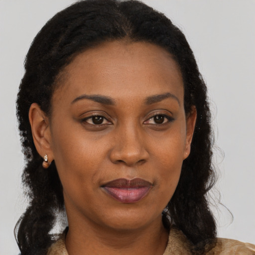 Joyful black young-adult female with medium  brown hair and brown eyes