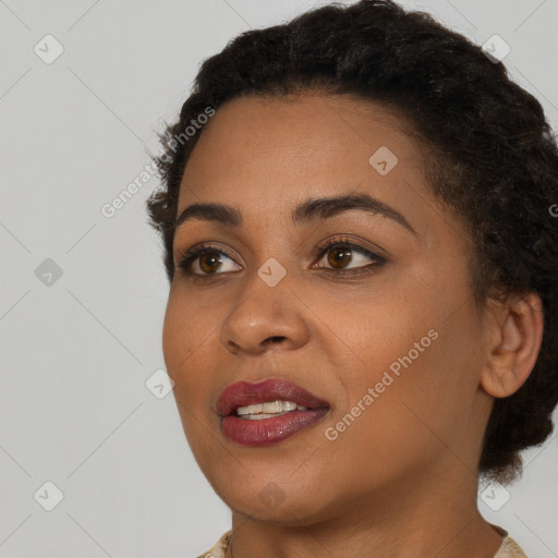 Joyful black young-adult female with short  black hair and brown eyes