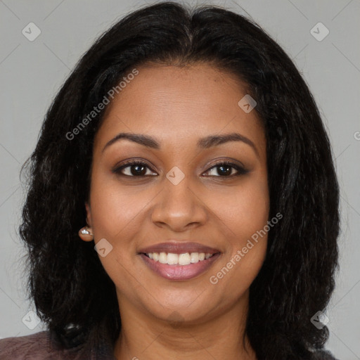 Joyful black young-adult female with long  brown hair and brown eyes