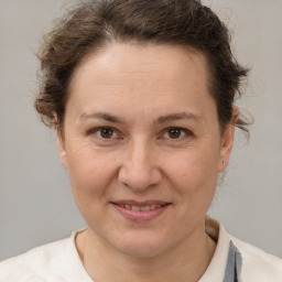 Joyful white adult female with short  brown hair and brown eyes