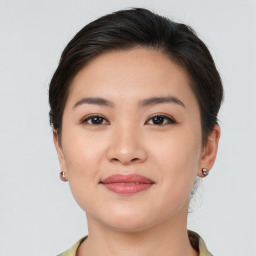 Joyful asian young-adult female with short  brown hair and brown eyes