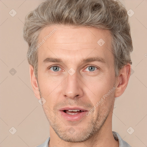 Joyful white adult male with short  brown hair and grey eyes