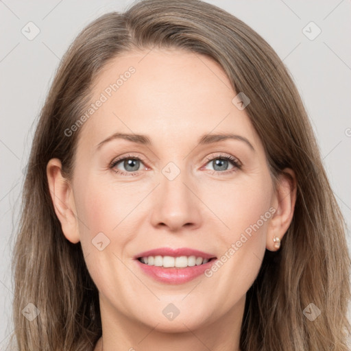 Joyful white adult female with long  brown hair and grey eyes