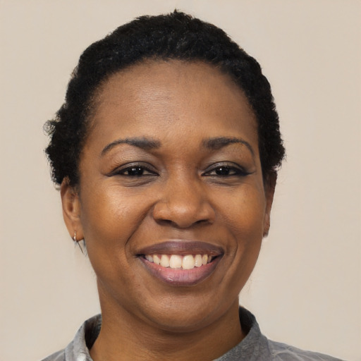 Joyful latino adult female with short  black hair and brown eyes