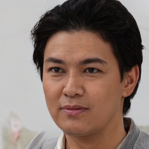 Joyful white adult female with short  black hair and brown eyes