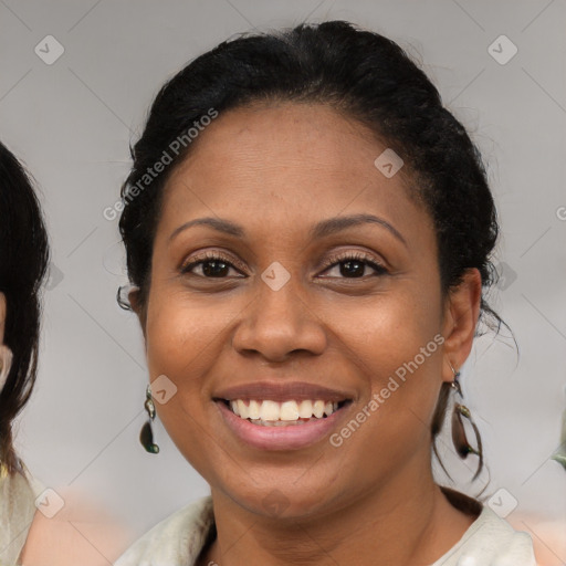 Joyful latino adult female with medium  brown hair and brown eyes