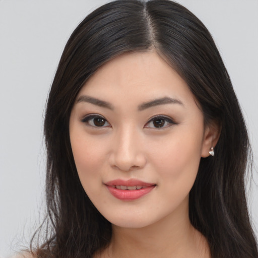 Joyful asian young-adult female with long  brown hair and brown eyes