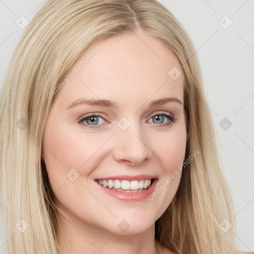 Joyful white young-adult female with long  brown hair and blue eyes