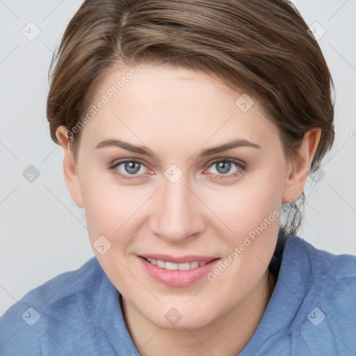 Joyful white young-adult female with medium  brown hair and blue eyes