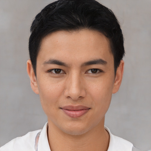 Joyful asian young-adult male with short  black hair and brown eyes