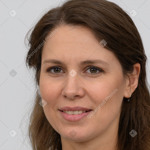 Joyful white adult female with long  brown hair and brown eyes