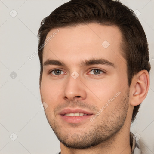 Joyful white young-adult male with short  brown hair and brown eyes