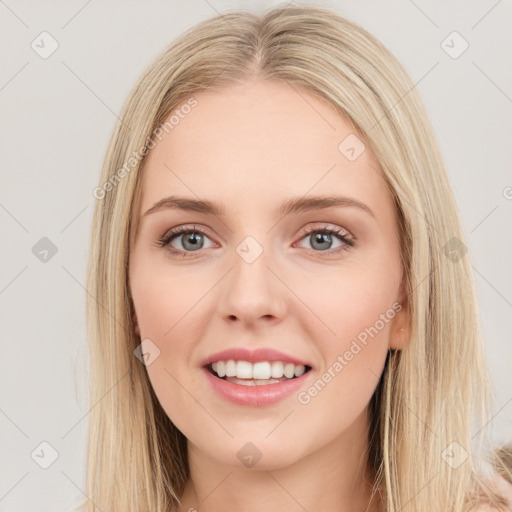 Joyful white young-adult female with long  brown hair and green eyes