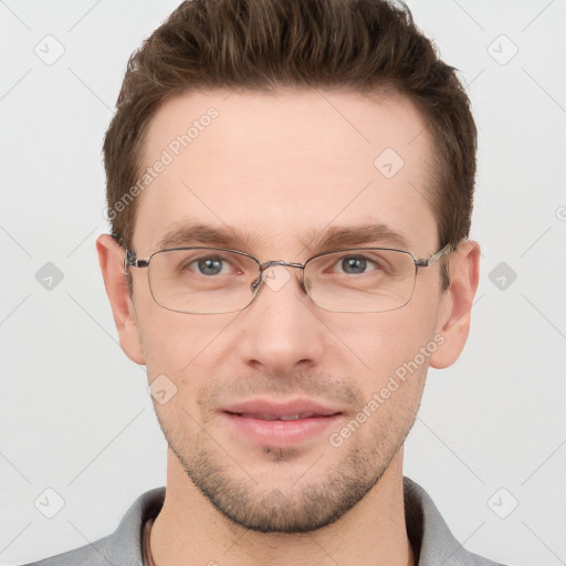 Joyful white adult male with short  brown hair and grey eyes