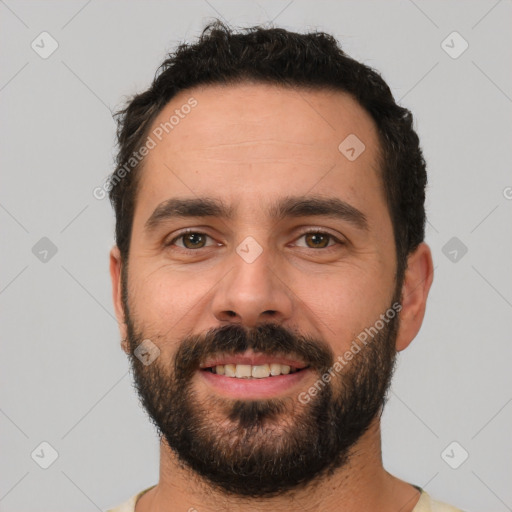 Joyful white young-adult male with short  black hair and brown eyes