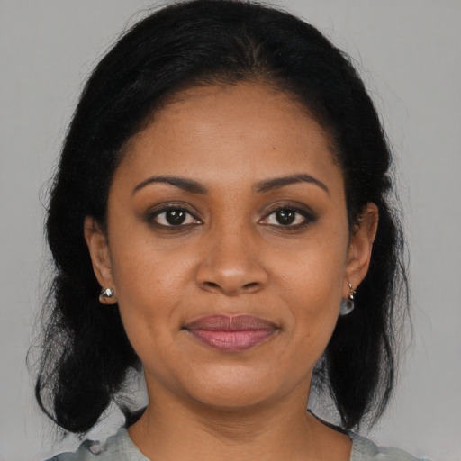 Joyful black young-adult female with medium  brown hair and brown eyes