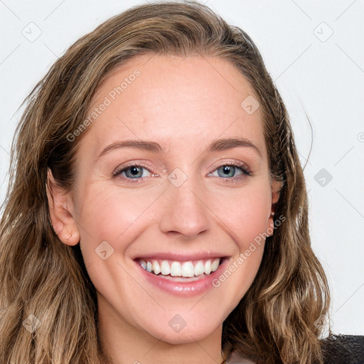 Joyful white young-adult female with long  brown hair and blue eyes