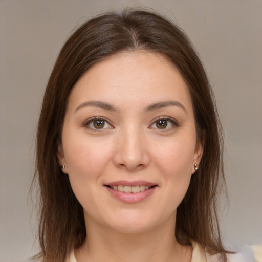 Joyful white young-adult female with medium  brown hair and brown eyes