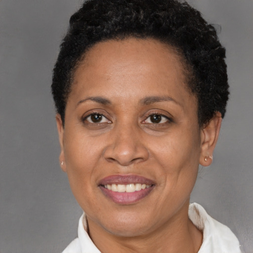 Joyful black adult female with short  black hair and brown eyes