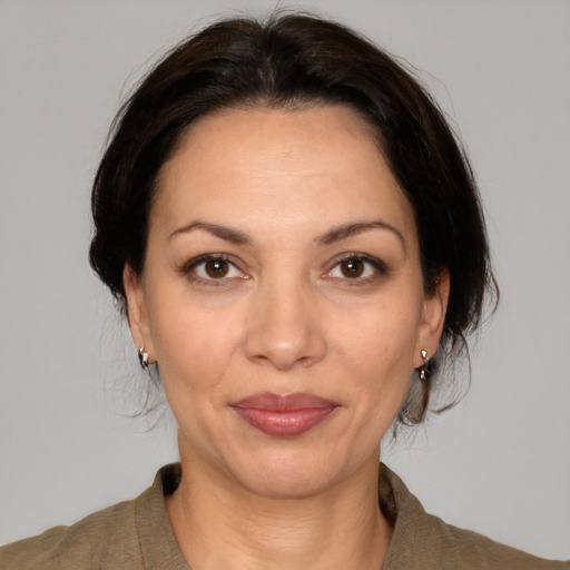 Joyful white adult female with medium  brown hair and brown eyes