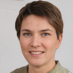 Joyful white young-adult female with short  brown hair and grey eyes