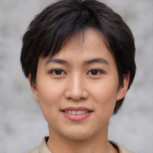 Joyful asian young-adult female with medium  brown hair and brown eyes