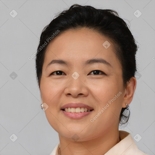 Joyful asian young-adult female with short  brown hair and brown eyes