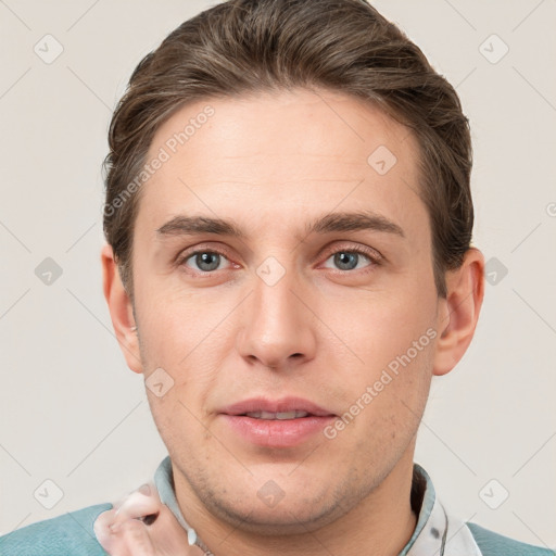 Joyful white young-adult male with short  brown hair and grey eyes