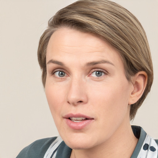 Joyful white adult female with medium  brown hair and grey eyes