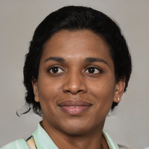 Joyful latino young-adult female with short  black hair and brown eyes