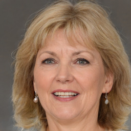 Joyful white middle-aged female with medium  brown hair and brown eyes