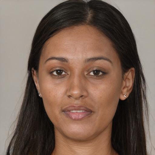 Joyful latino adult female with long  brown hair and brown eyes
