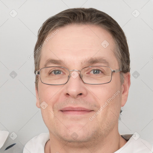 Joyful white adult male with short  brown hair and grey eyes