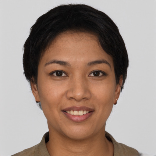 Joyful latino young-adult female with short  black hair and brown eyes