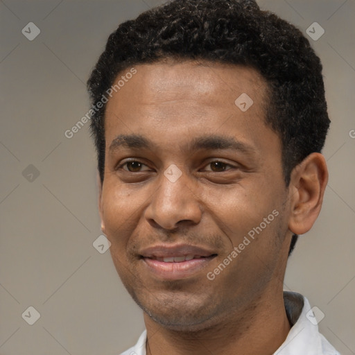 Joyful black young-adult male with short  black hair and brown eyes