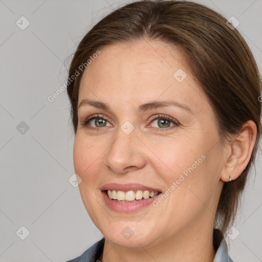 Joyful white adult female with medium  brown hair and grey eyes