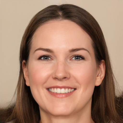 Joyful white young-adult female with long  brown hair and brown eyes