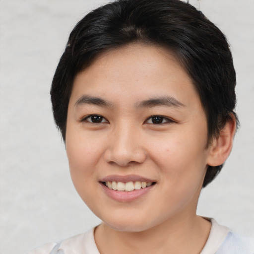 Joyful asian young-adult female with short  brown hair and brown eyes