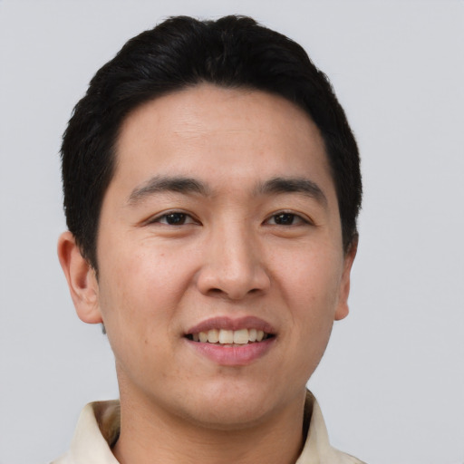 Joyful asian young-adult male with short  black hair and brown eyes