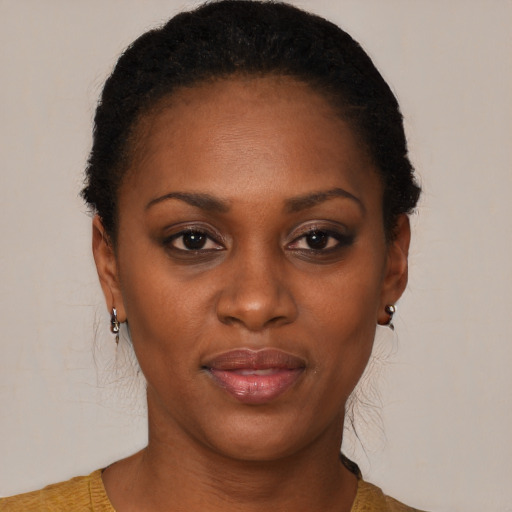 Joyful black young-adult female with short  black hair and brown eyes