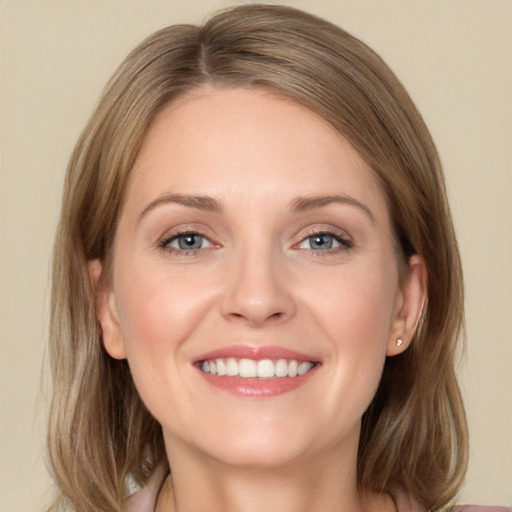 Joyful white young-adult female with medium  brown hair and grey eyes