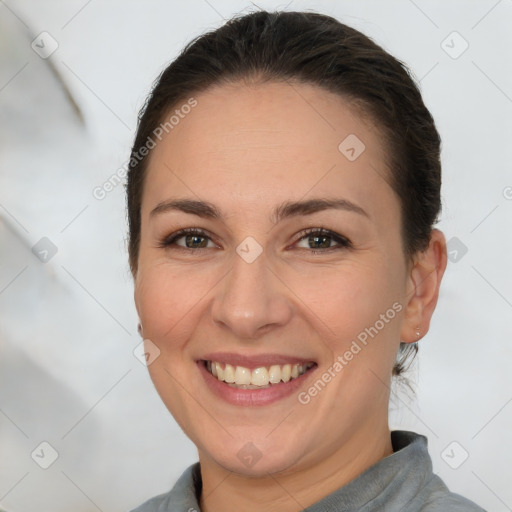 Joyful white young-adult female with short  brown hair and brown eyes